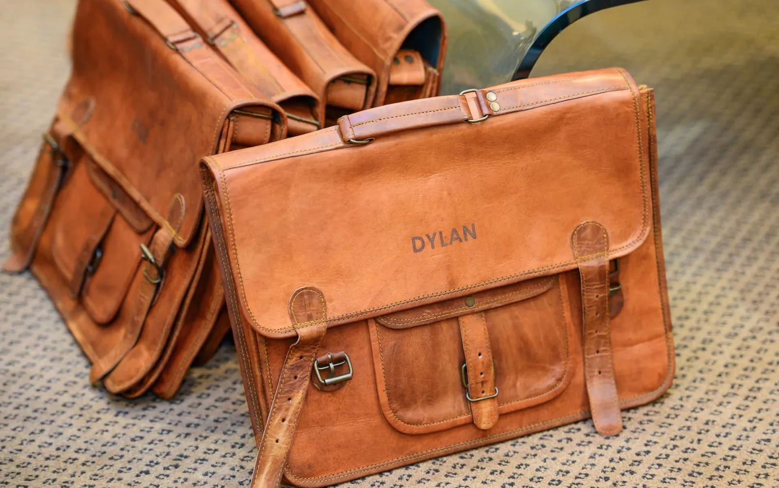 Personalised tan leather satchels with engraved names